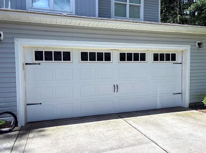 Carriage-style double door with windows and black hardware