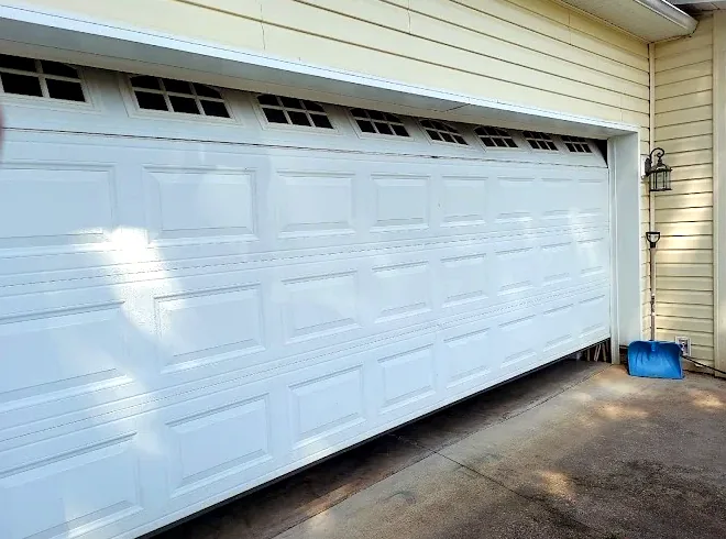Garage door hanging crooked after coming off track
