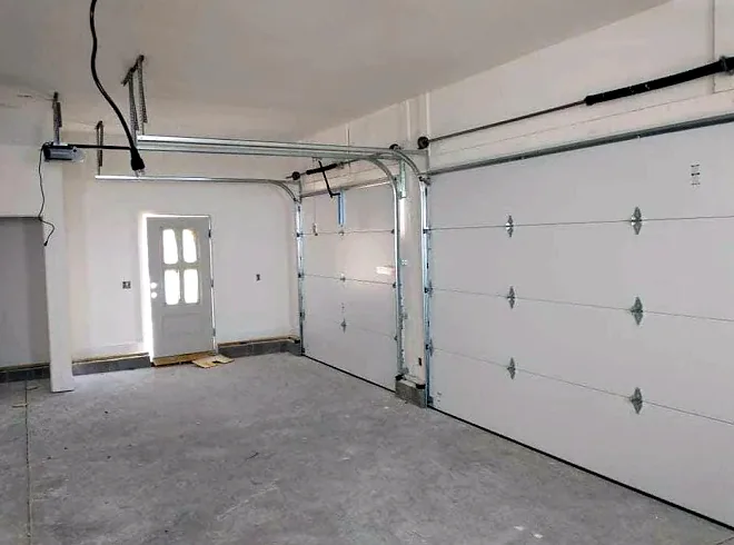 Two newly installed garage doors inside a new garage