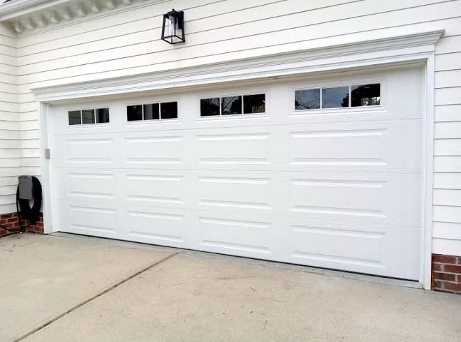 White garage door with top windows on a colonial-style home